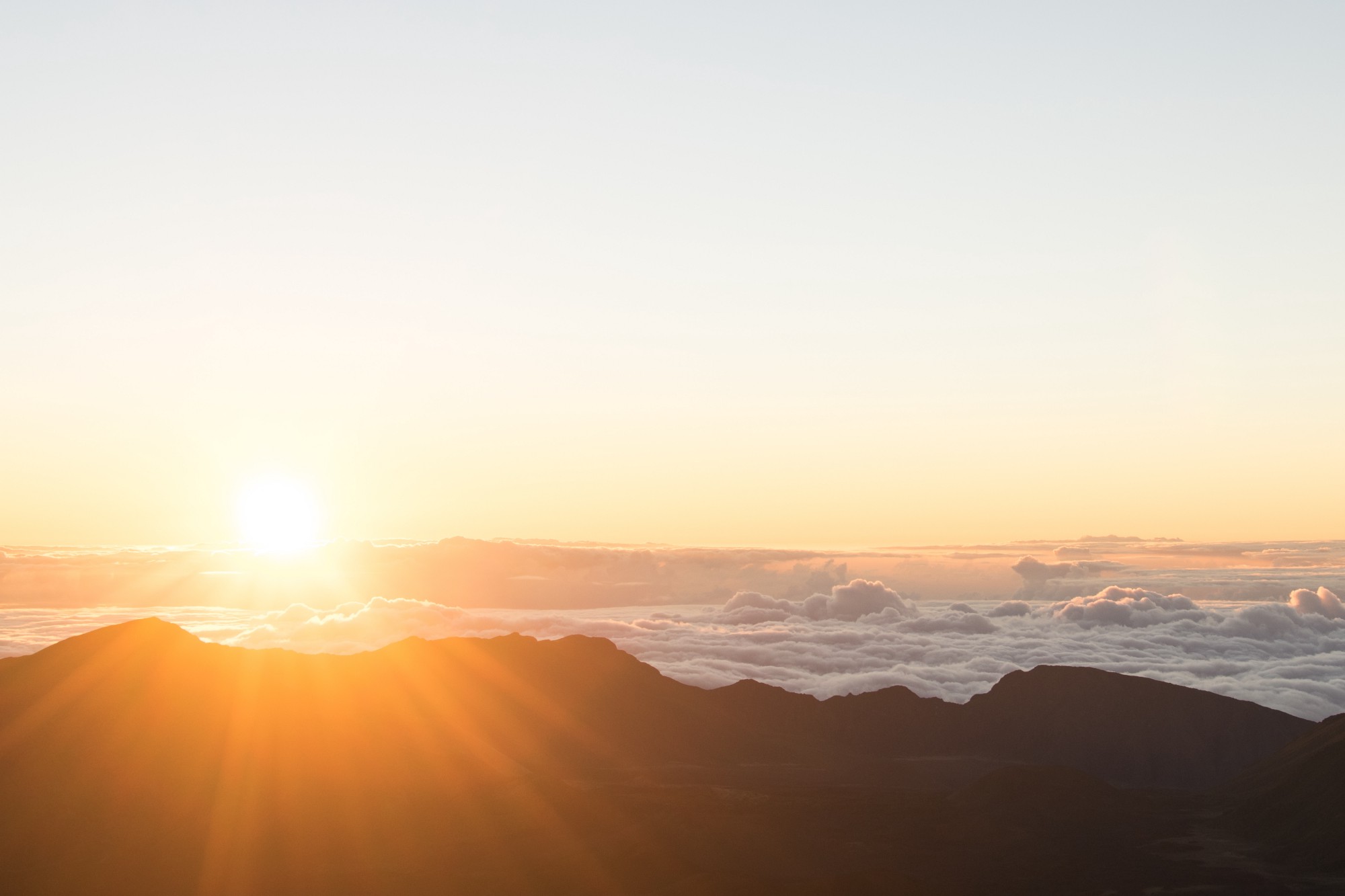 'The sun rising over the mountains.' by Alice Donovan Rouse on Unsplash